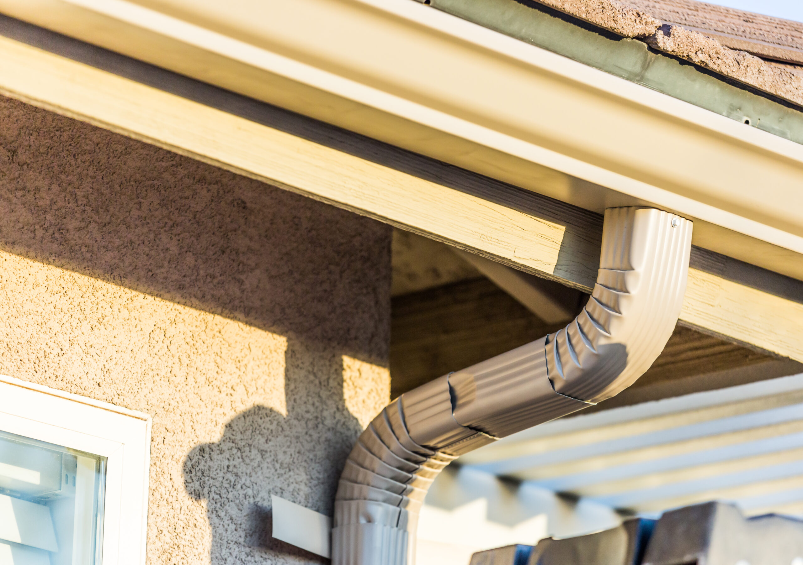 Close-up of a house rain gutter and downspout system